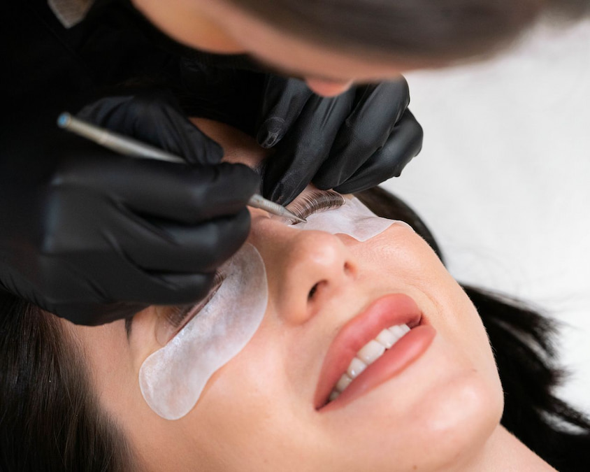 Technician applying lift solution over a silicone shield