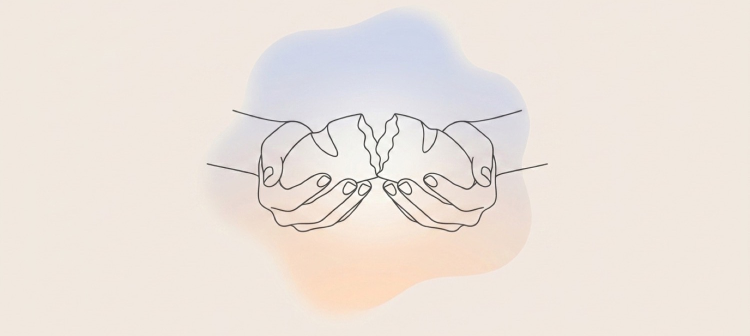 Two hands gently breaking bread, a symbol of God's love and grace shared