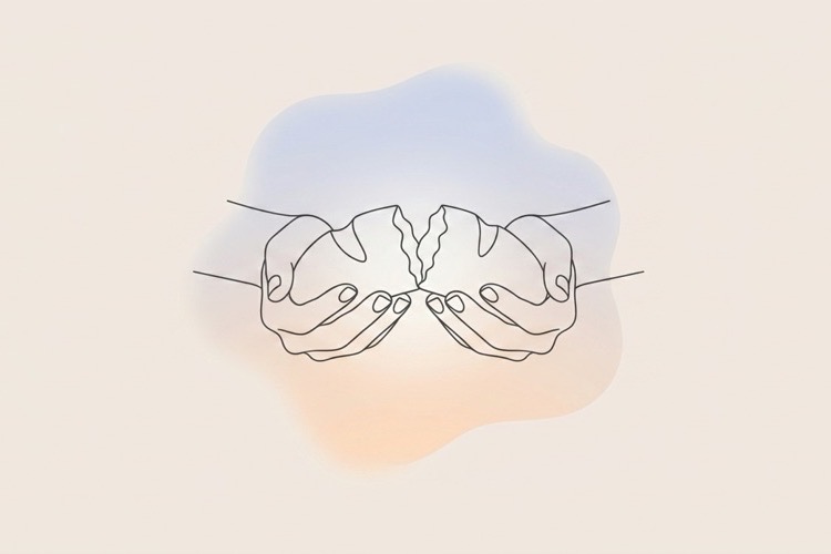 Two hands breaking bread together, representing grace and generosity