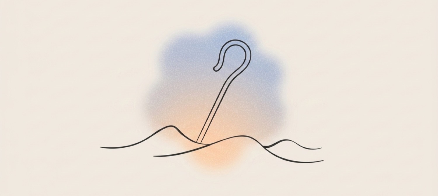 Shepherd's crook resting on green rolling hills