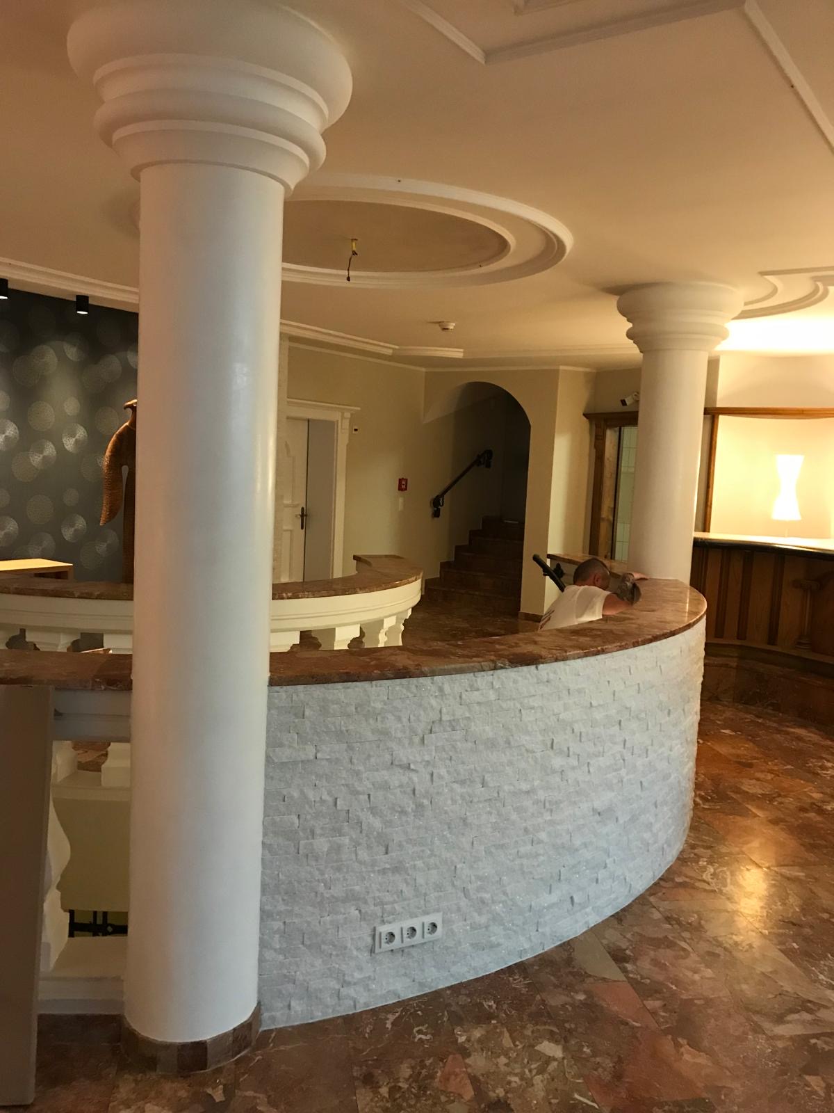Elegante Rezeption mit Säulen und Steinverkleidung von Malerbetrieb Münster