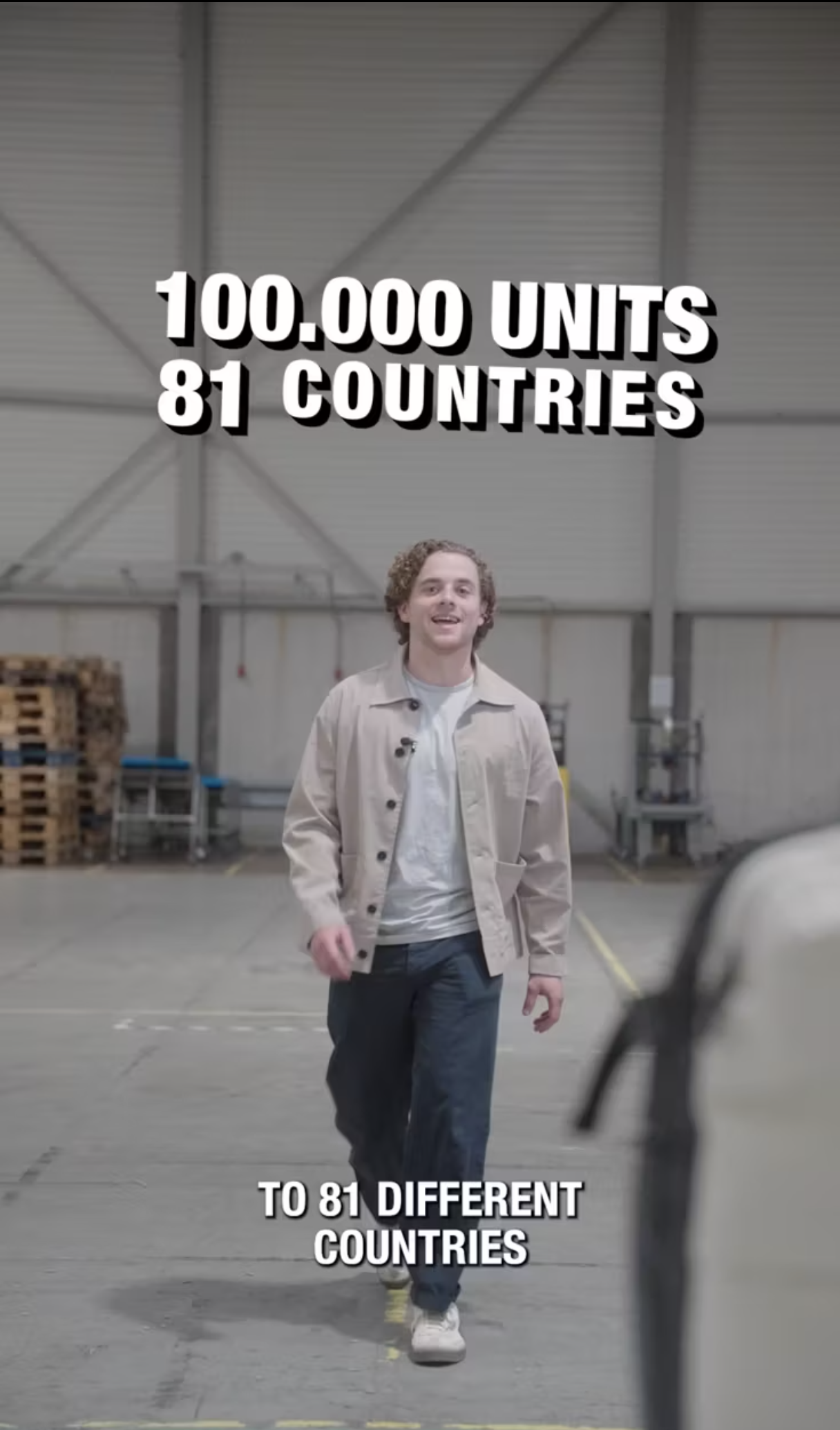 A young man walking in a warehouse