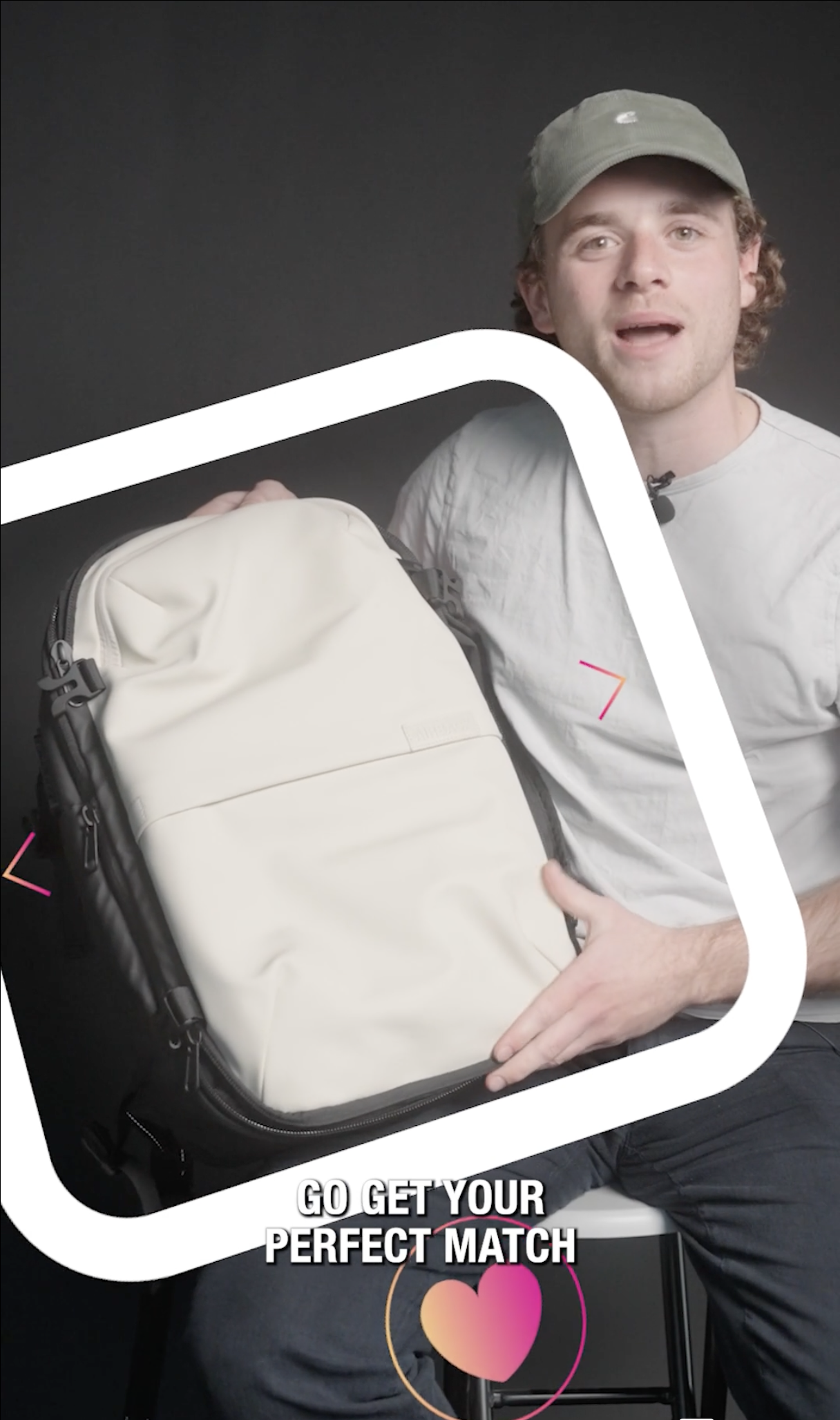 A young man sitting with a backpack on his lap