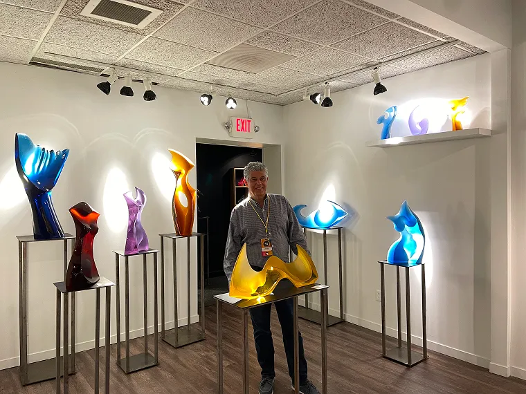 Latchezar Boyadjiev standing between glass sculputres
