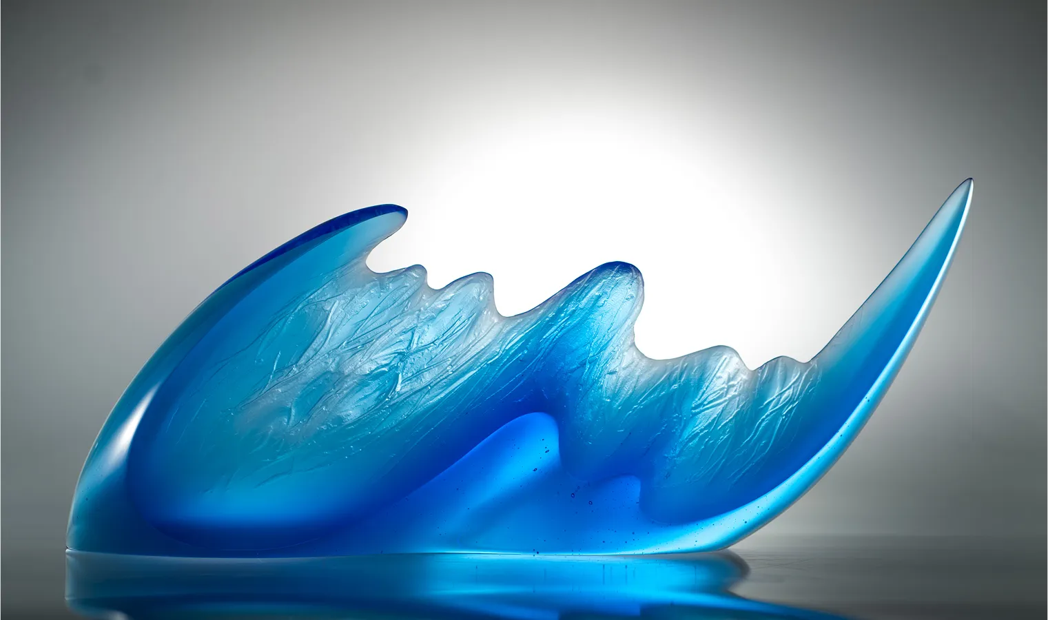 Motion sculpture, 26x12x4 inches, blue glass form