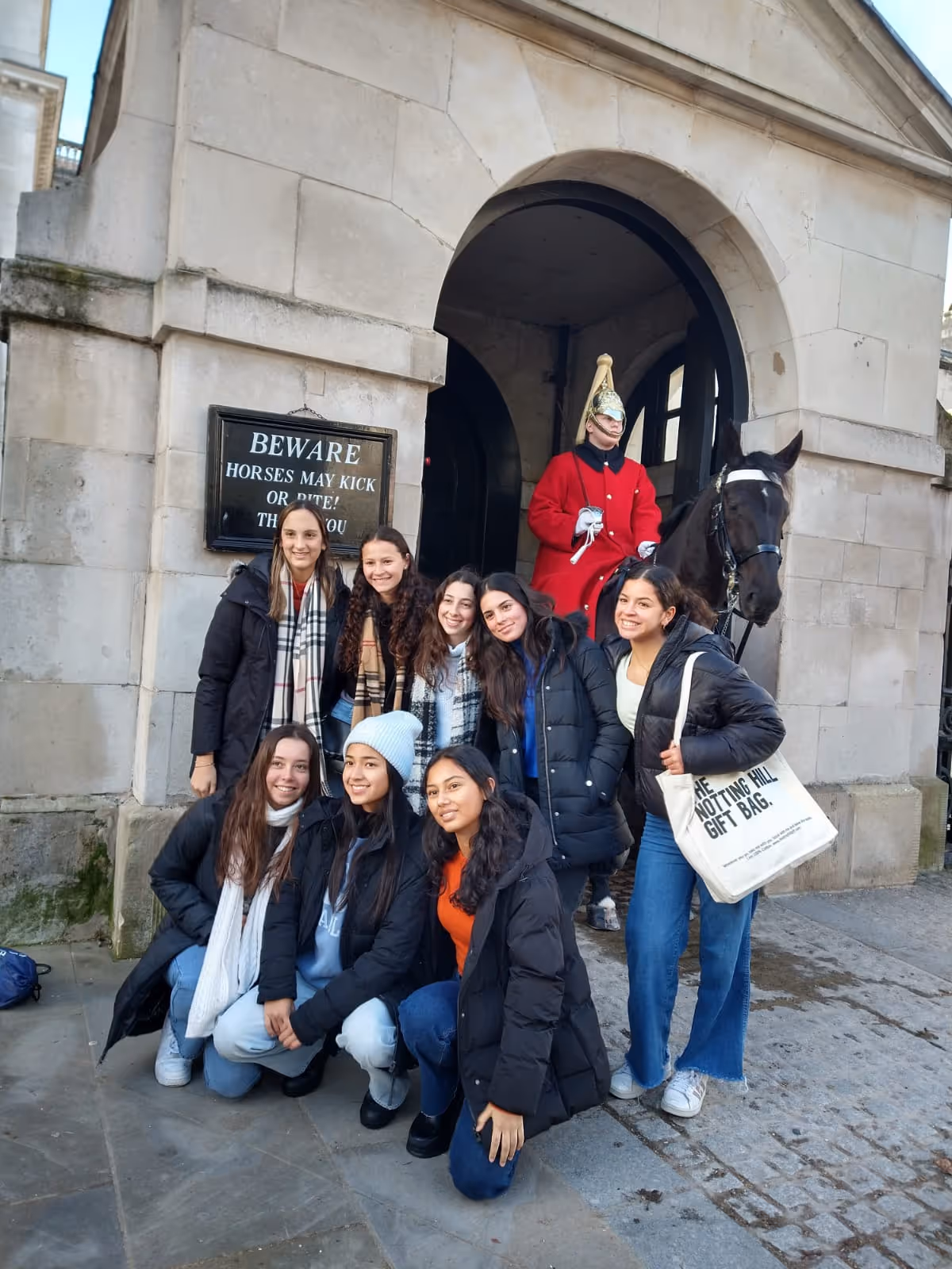 EDM exchange students posing for a photo in front of the Royal Guards