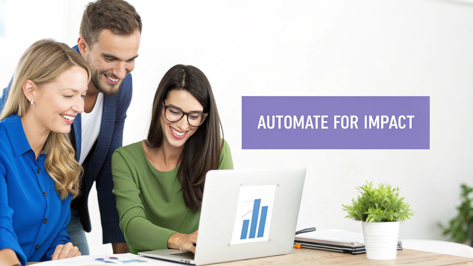 Three business professionals smiling while reviewing analytics charts on laptop discussing automation strategies