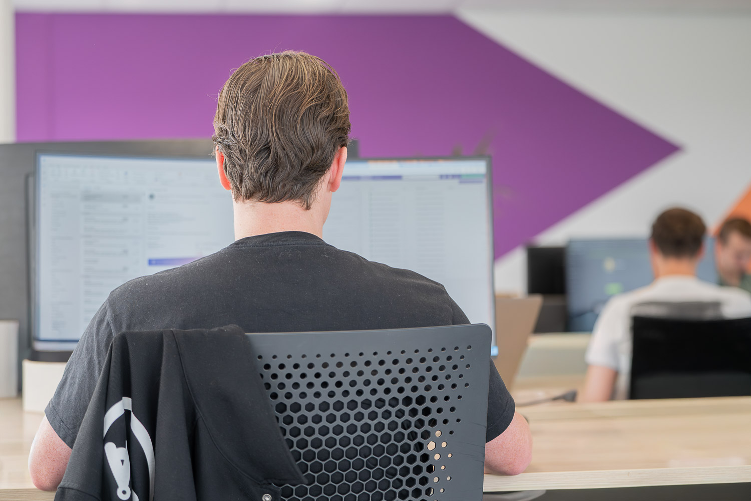 Our security officer works behind his laptop at the PuraSec office.