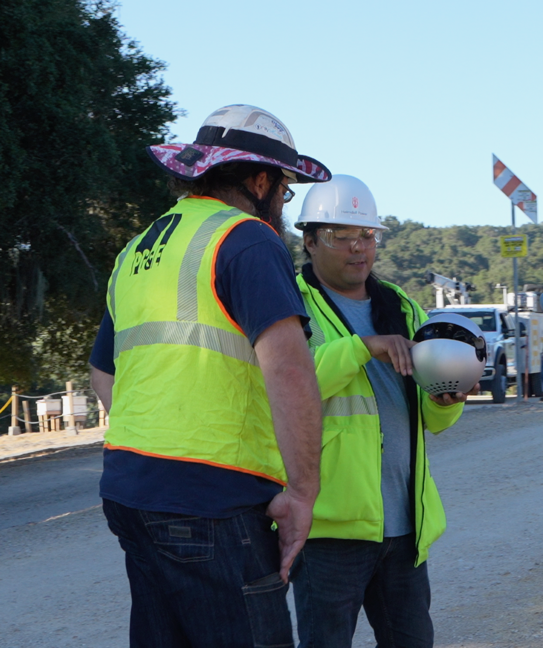 A Heimdall Power employee training a PG&E worker