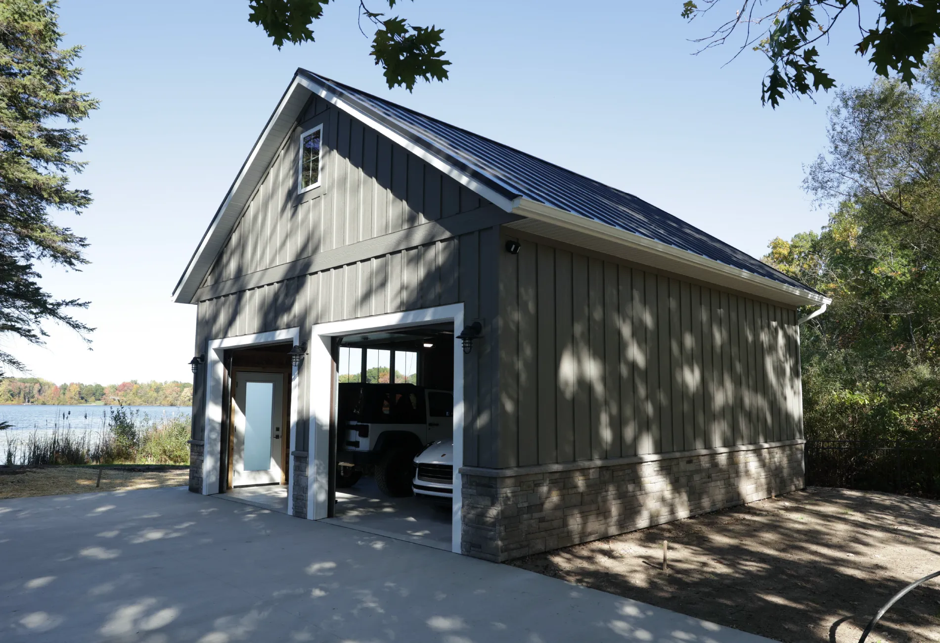 Rockford lakefront barn with a double-stall garage, featuring large windows, an entry door, and a spacious "bump-out" for a workshop or entertaining.