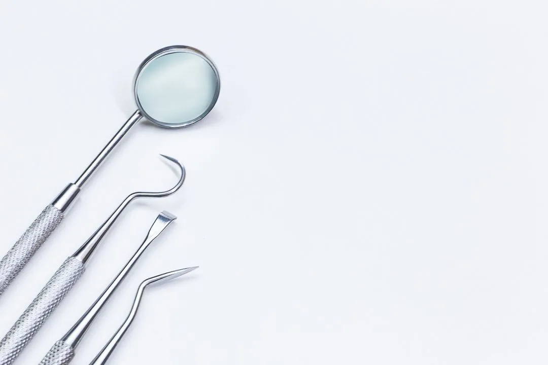 A pair of dental tools sitting on top of a table
