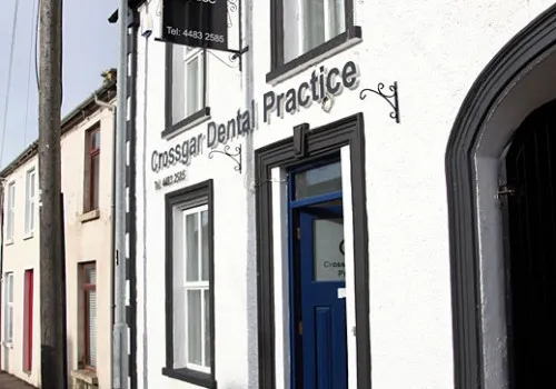 Crossgar Dental Practice storefront with blue door and white building
