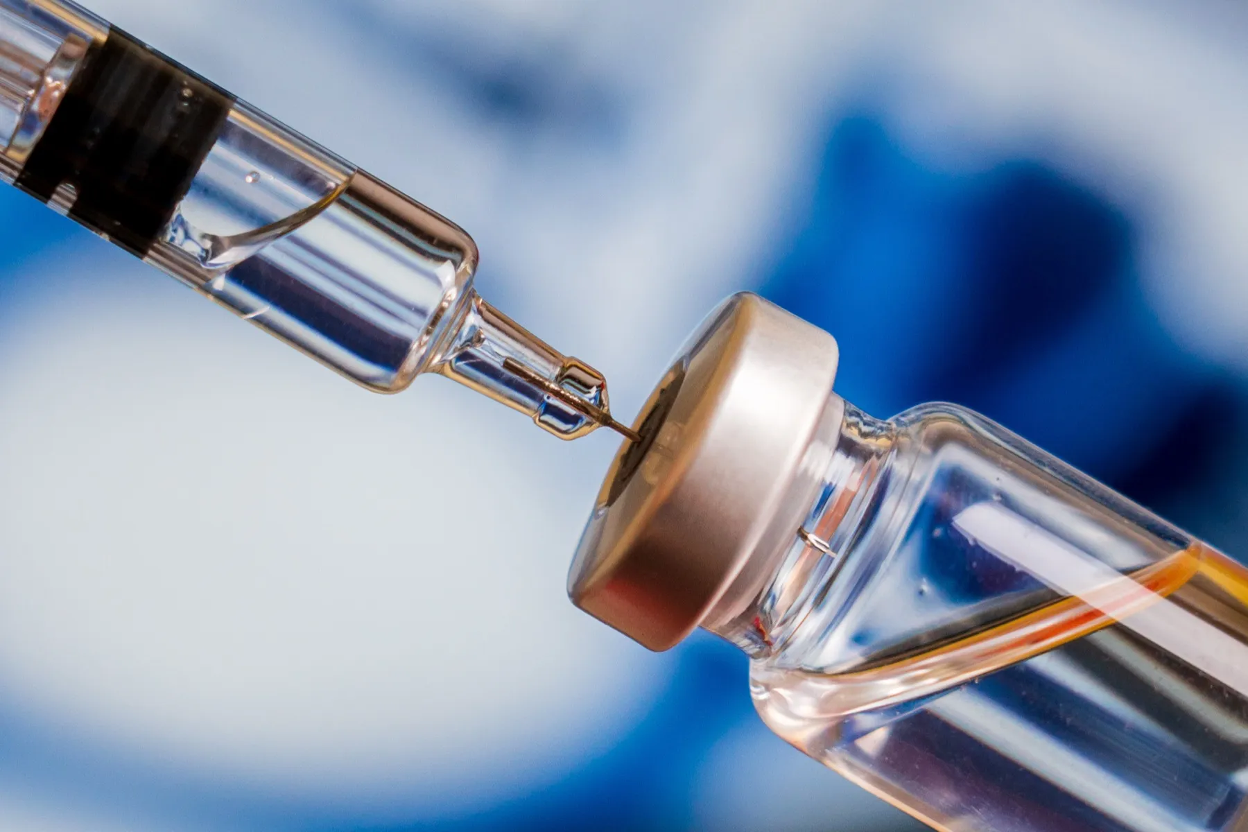 Close-up of medical syringe or vaccine needle with liquid