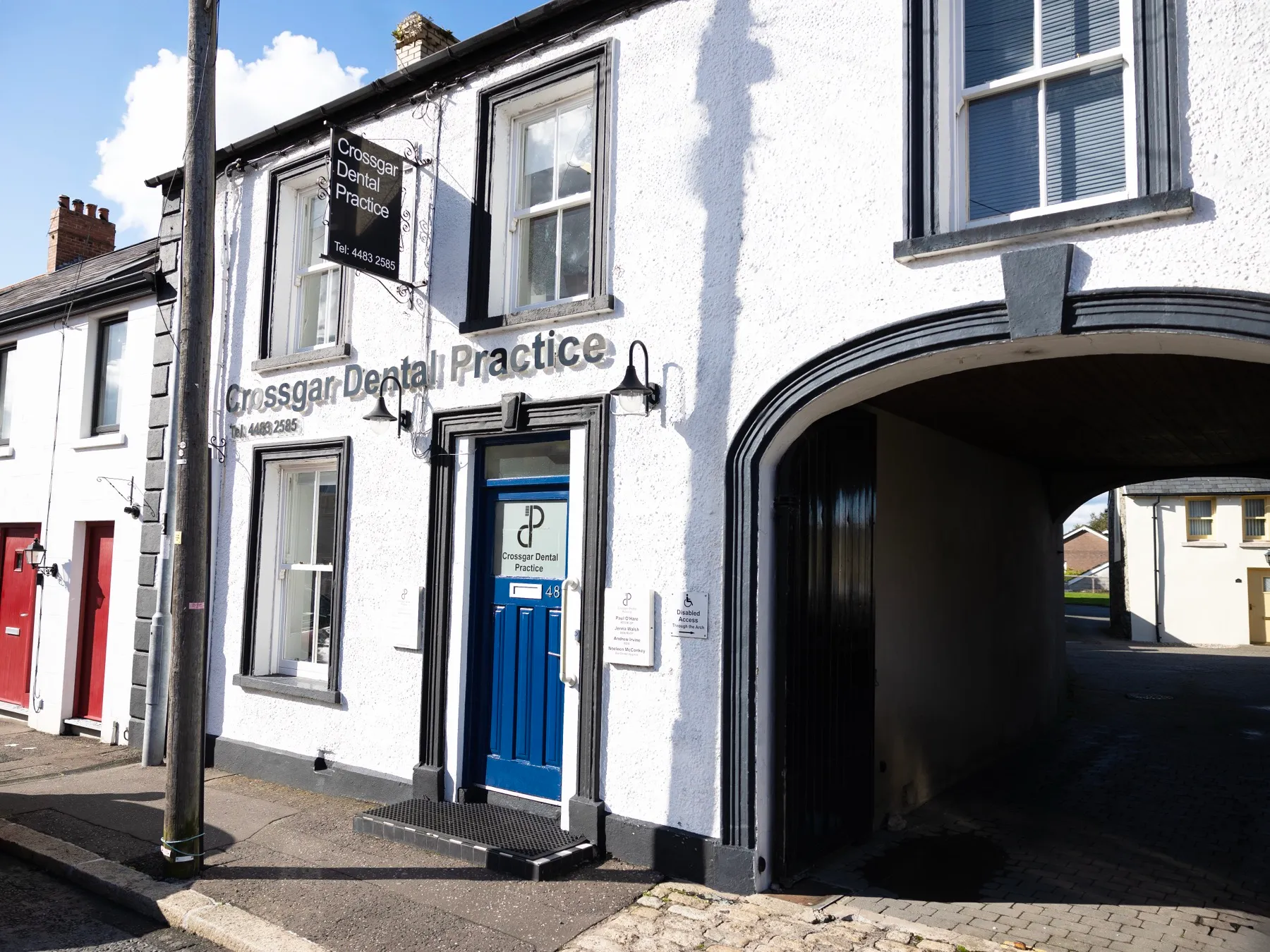 White building with blue door housing Crossgar Dental Practice