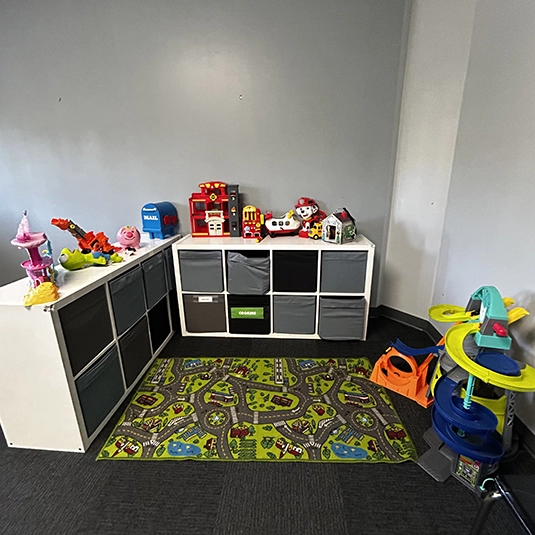 Play room with Paw Patrol toys, cubby storage, road-themed play mat
Play therapy room at our San Diego ABA clinic with toys, cubby storage, and a road-themed play mat for imaginative learning.