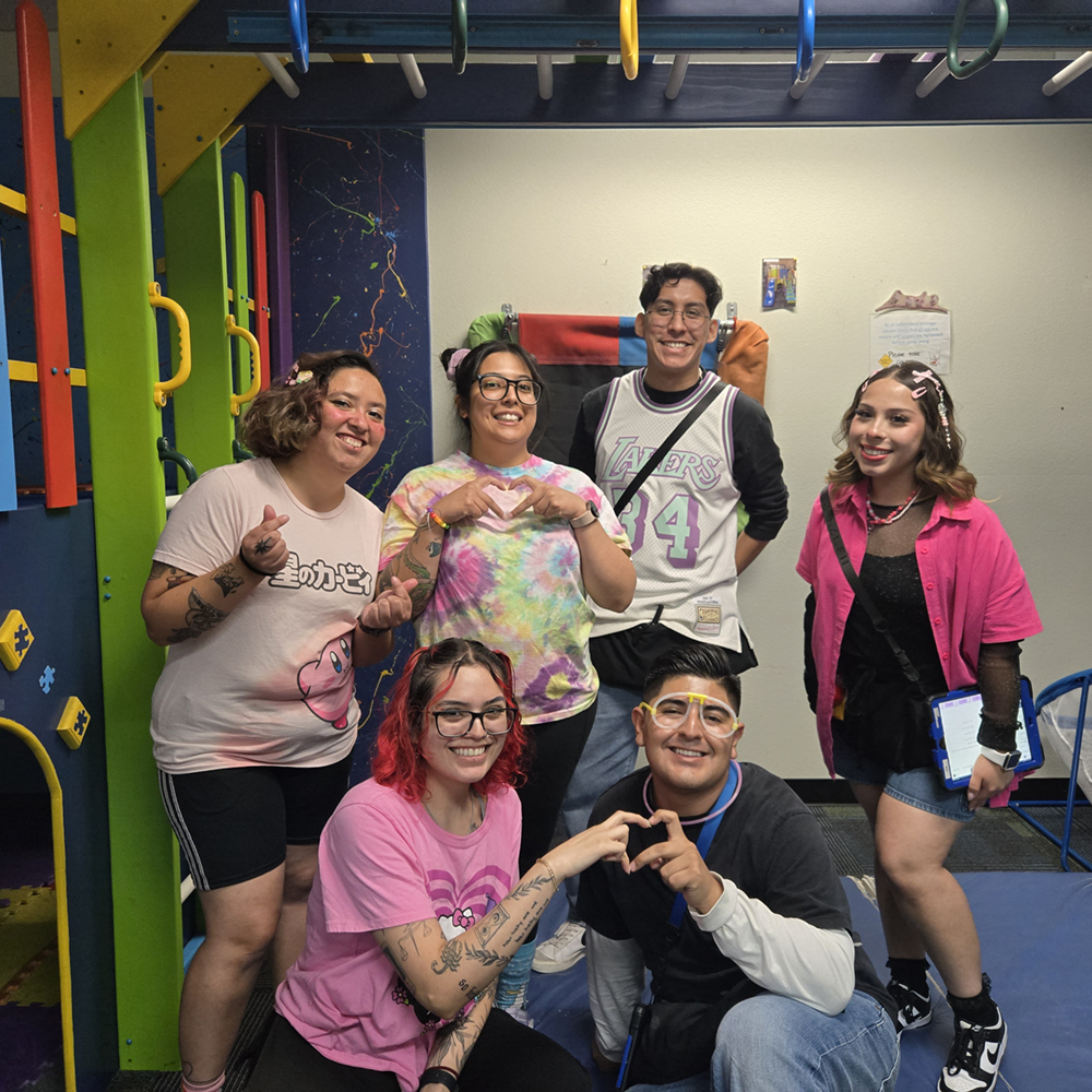 The Lancaster clinic's team, six smiling staff members posing together in the sensory gym.