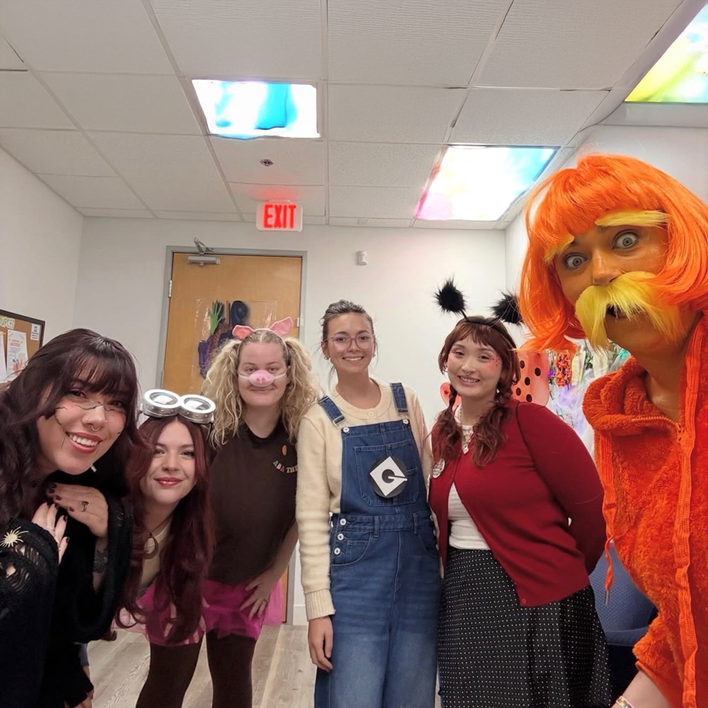 The Temecula Valley clinic's team, a group of smiling staff members gathered together in costume for a clinic dress-up day.