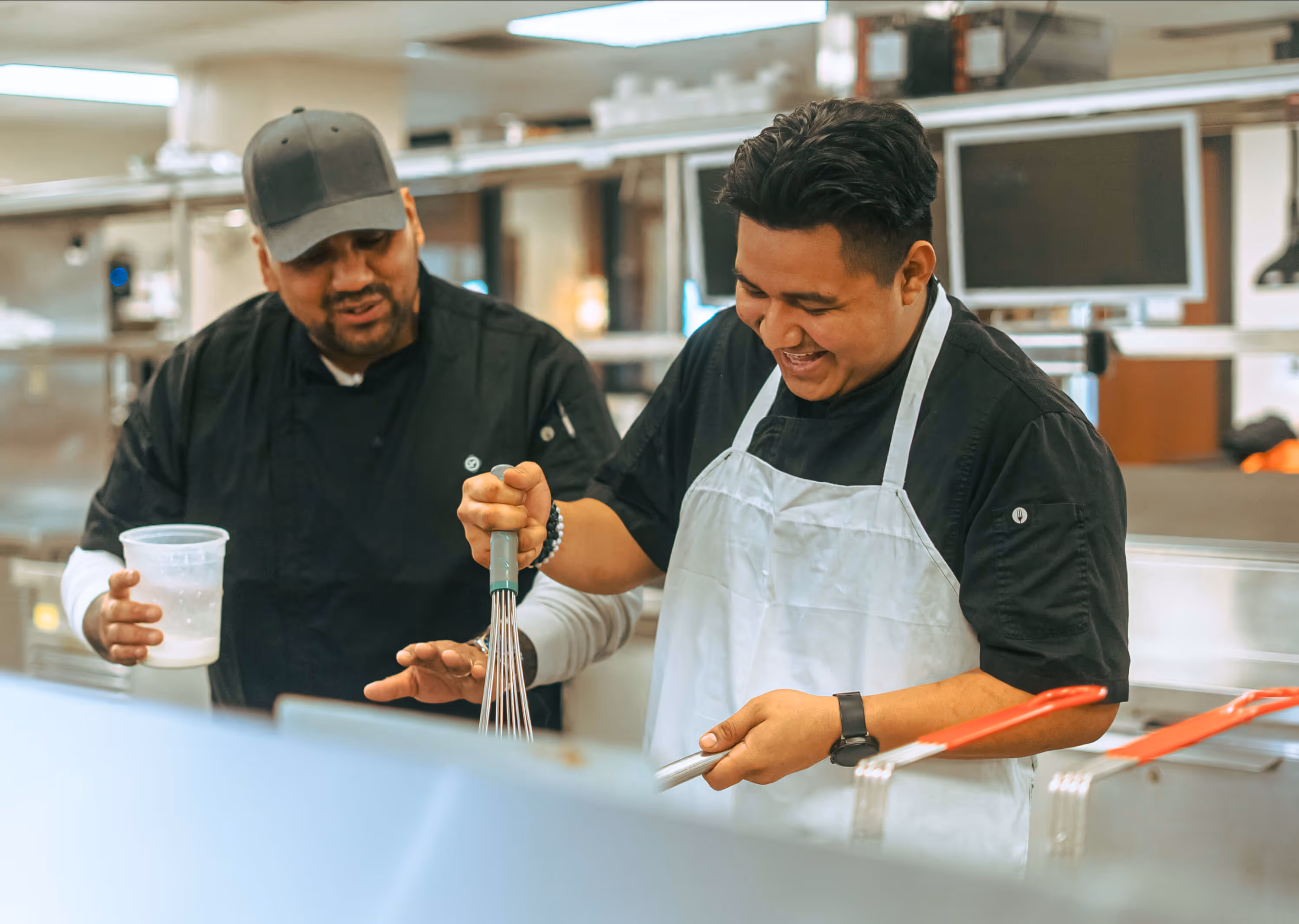 Men cooking together with Central tools and appliances