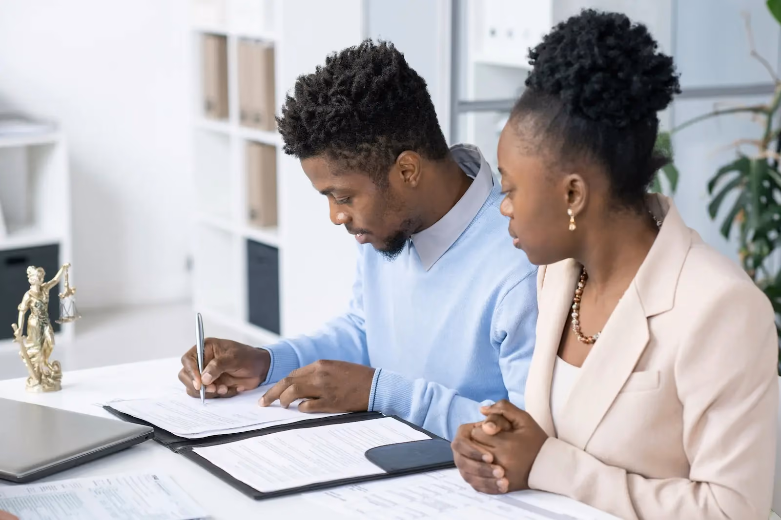 Two attorneys reviewing legal documents at a law firm office
