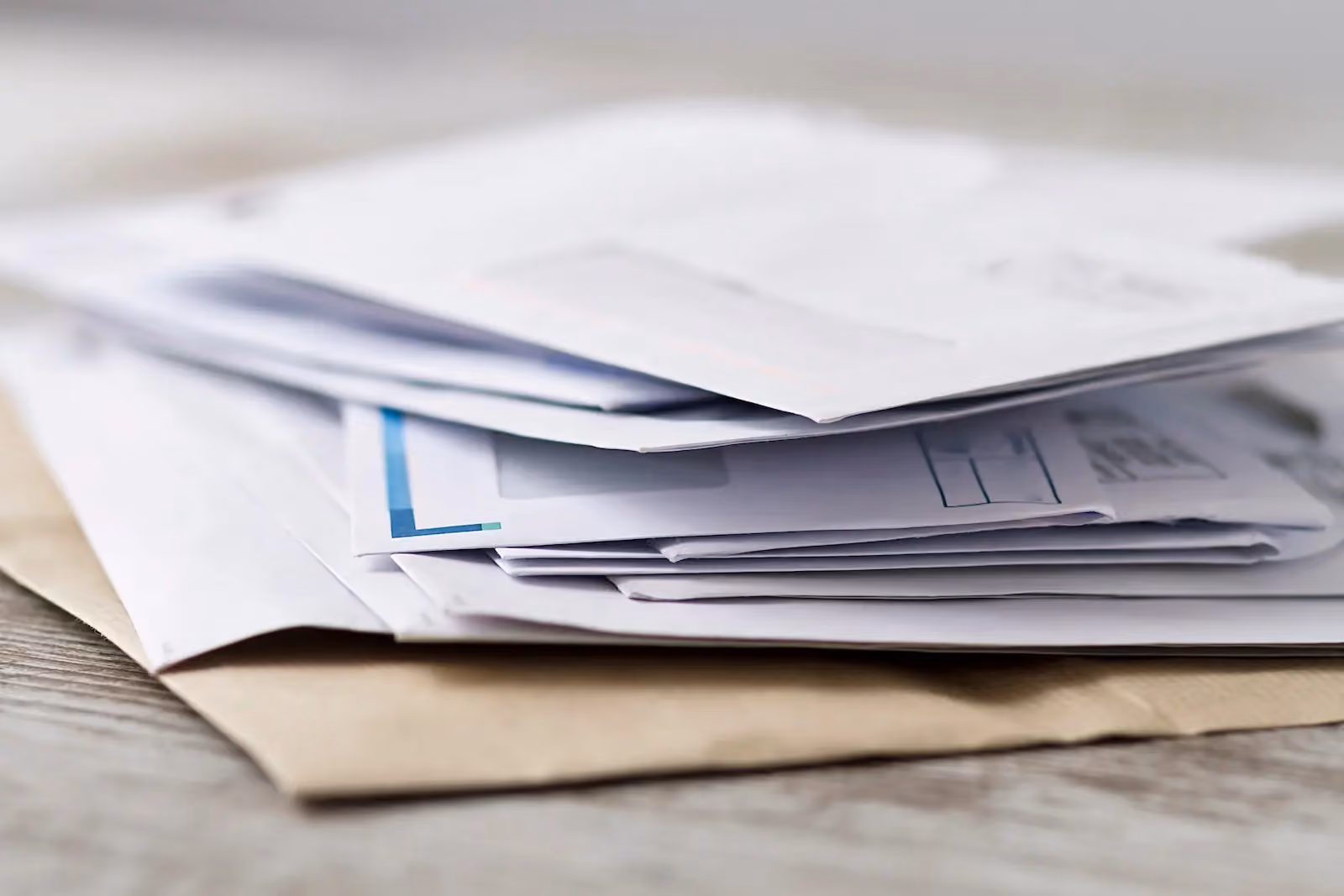 Stack of unopened business mail and envelopes representing high-volume enterprise mail processing