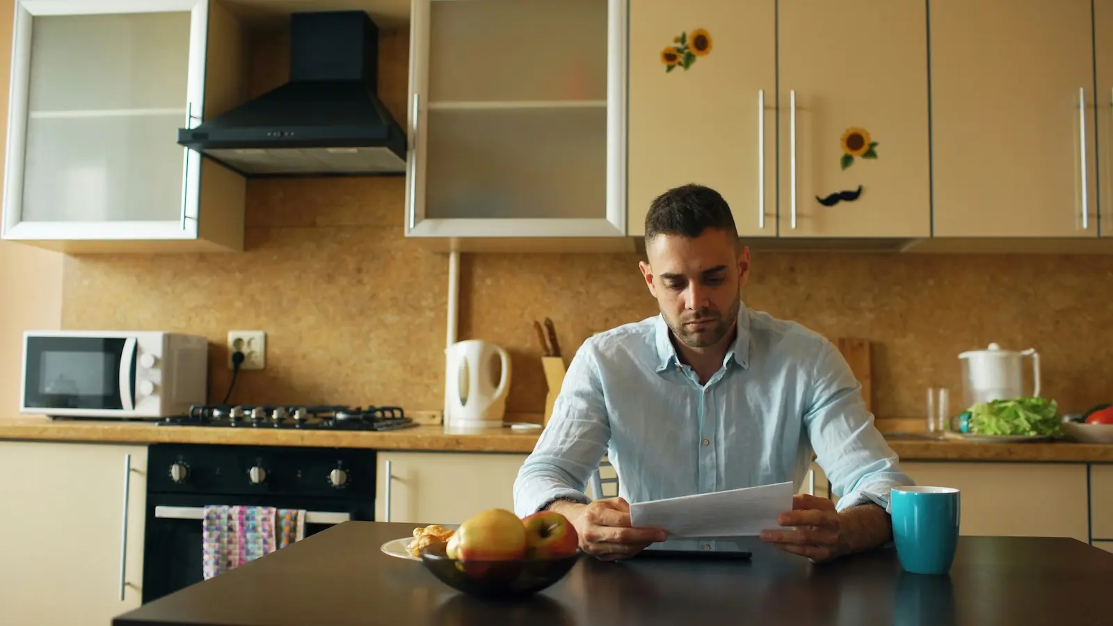 Small business owner reviewing physical mail at a home kitchen table — an alternative to LegalZoom Virtual Mail