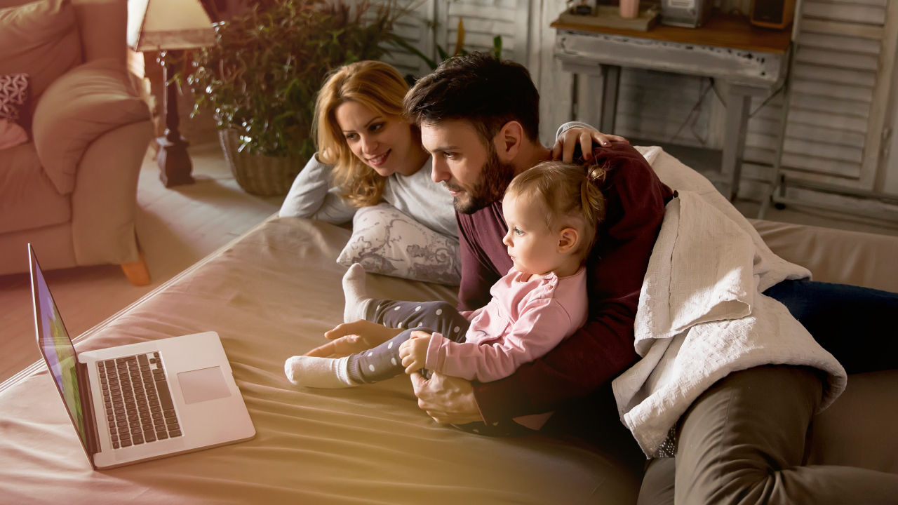 A loving family watching something on their laptop