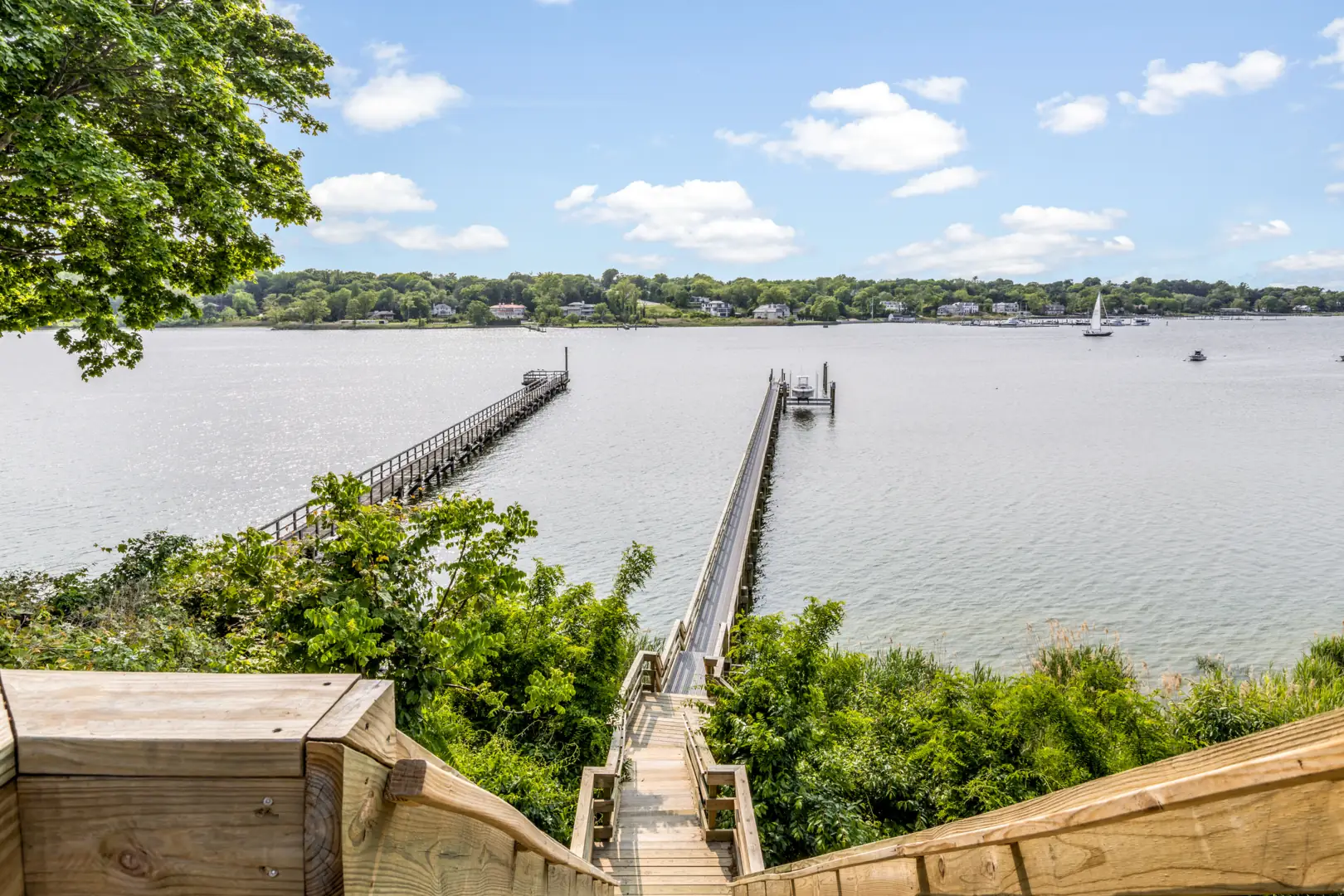 Wooden piers reaching into Manhasset Bay on a summer day