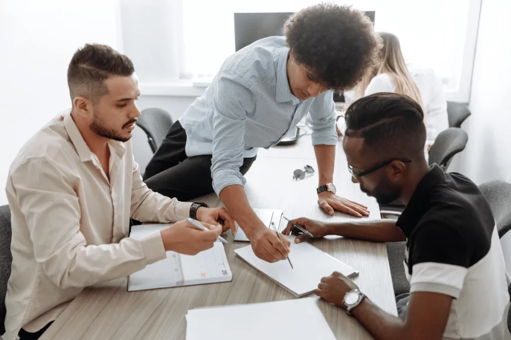 Team collaborating on a project with detailed discussions at a conference table.