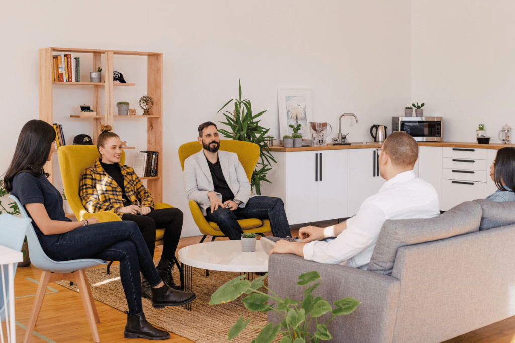 A group of people sitting on couches in a living room.