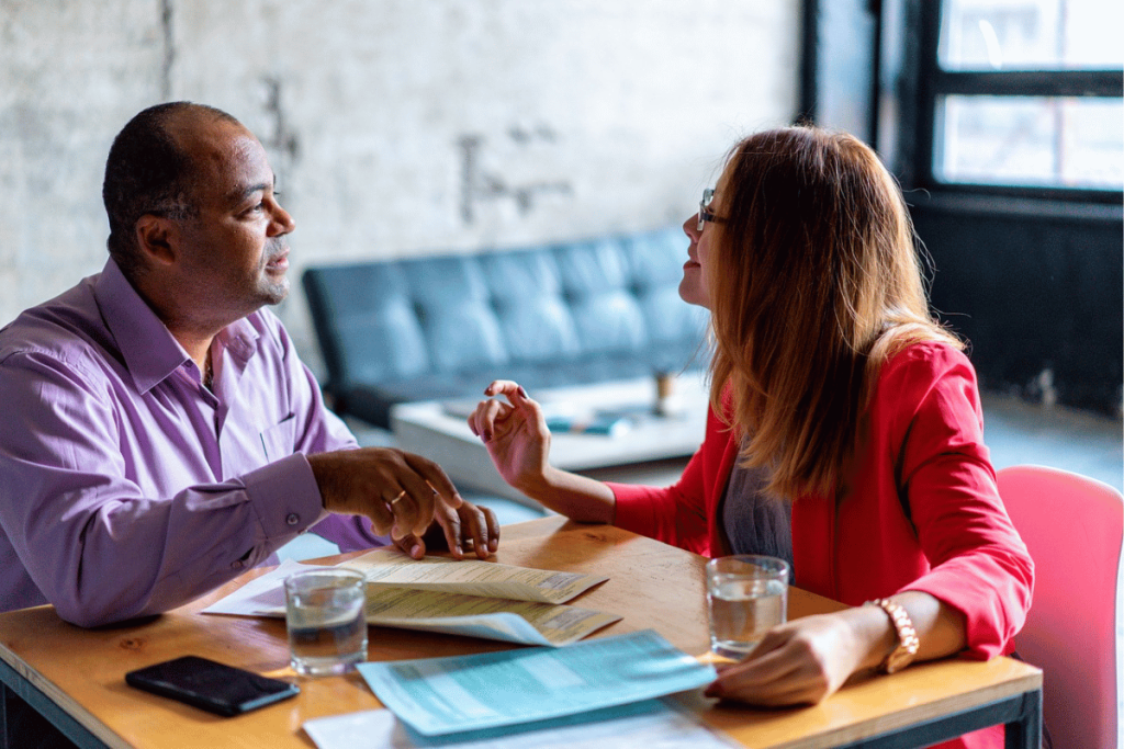 A group of people sitting at a table having a conversation.