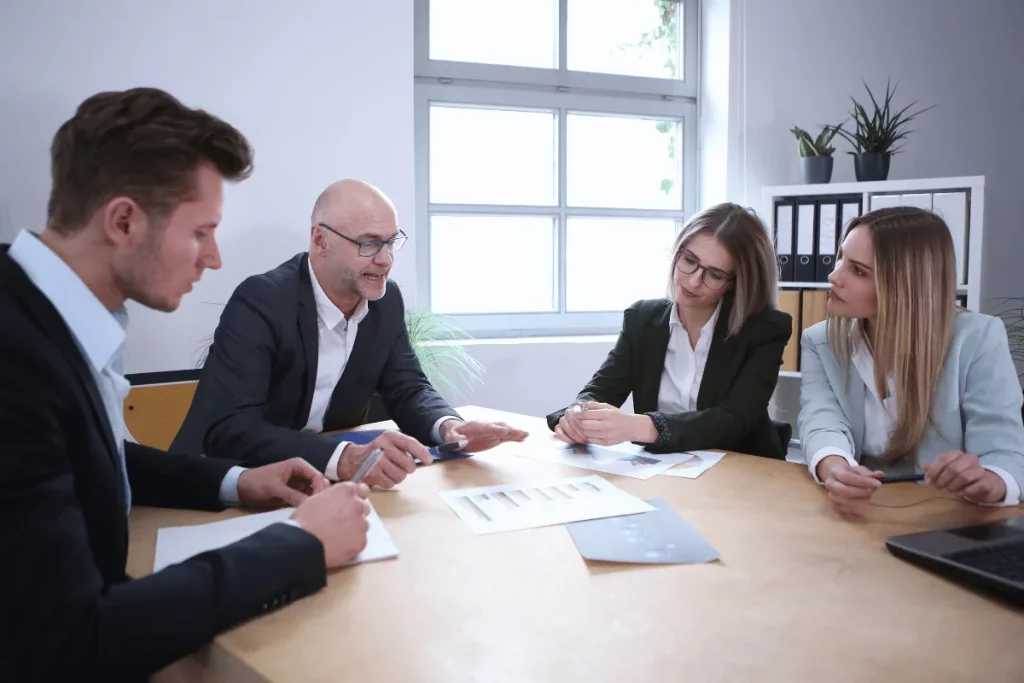 Business colleagues analyzing reports together in an office meeting.