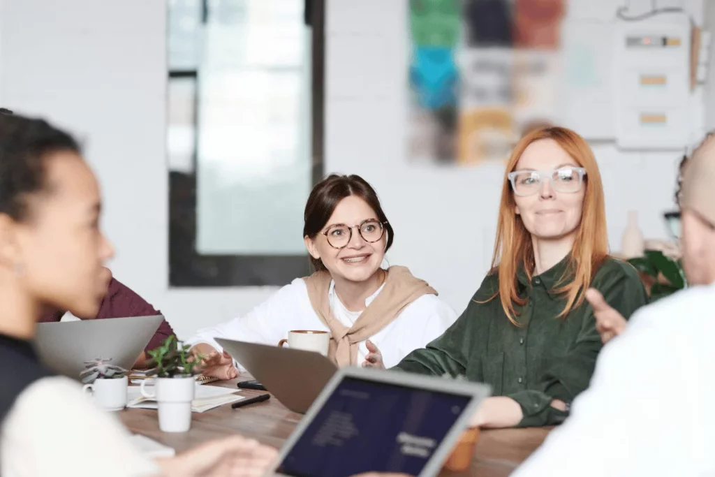 A group of colleagues engaged in a lively discussion around a table.