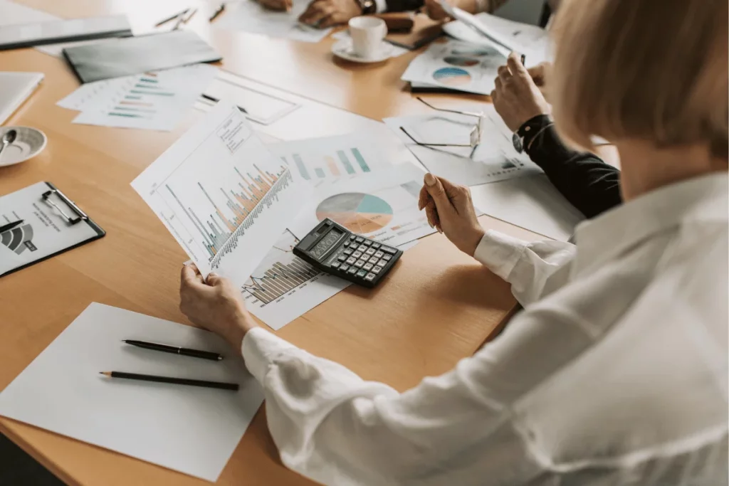 Executive reviewing detailed accounting charts in an office setting.