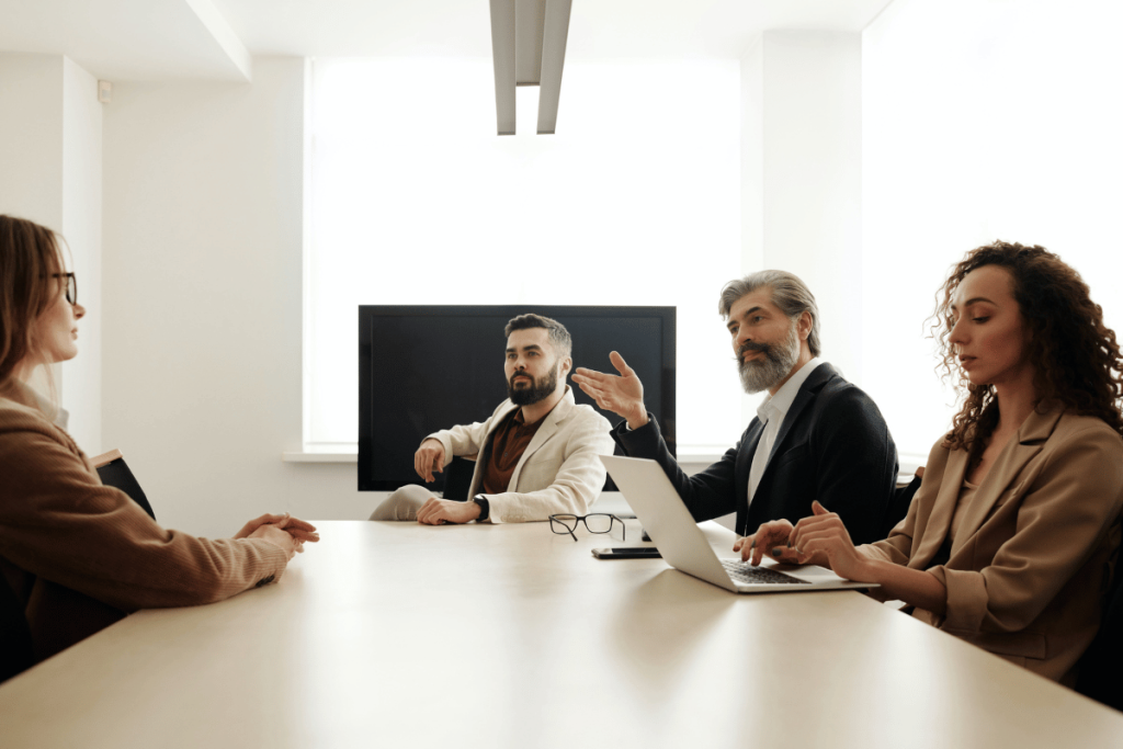Elegant businesspeople in a collaborative session with a laptop and notes.