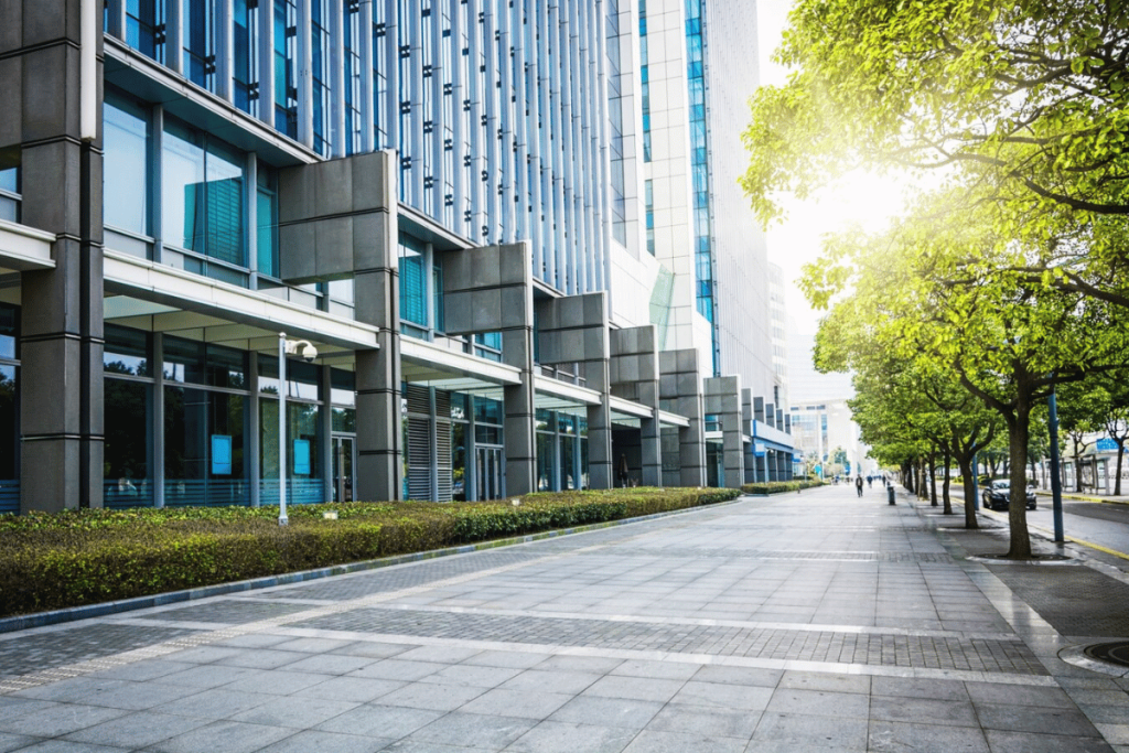 An empty street lined with tall buildings and trees.