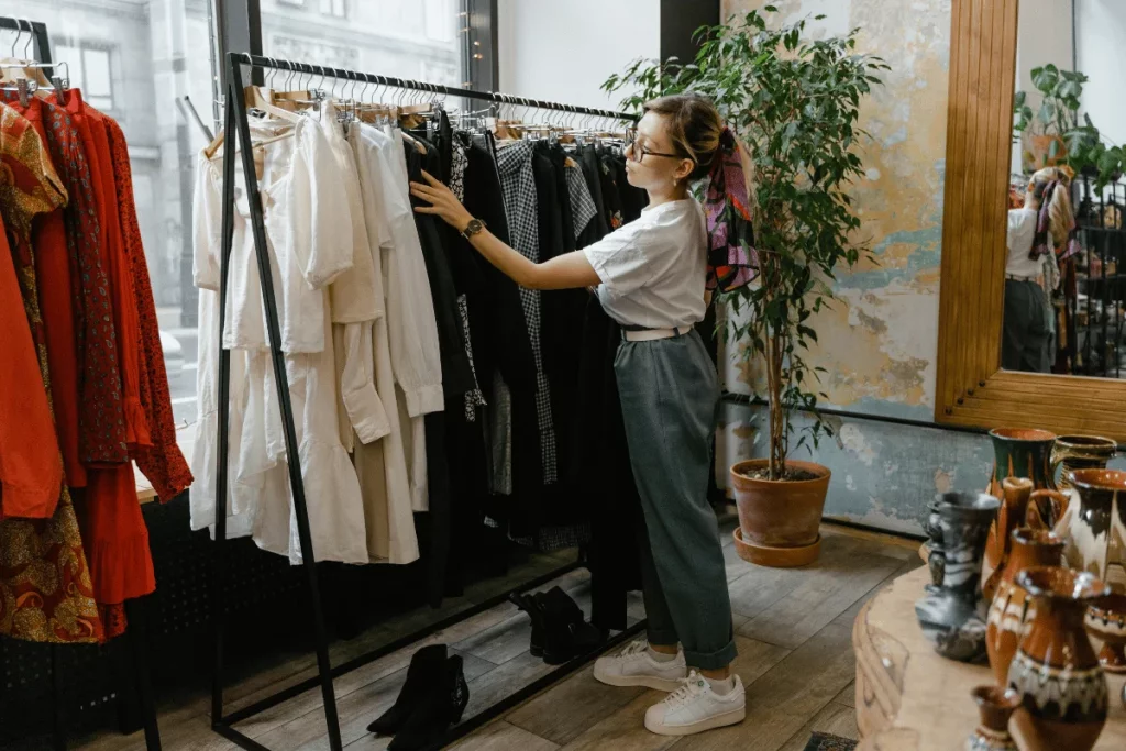 Shopper selecting clothing from a rack in a trendy retail store.
