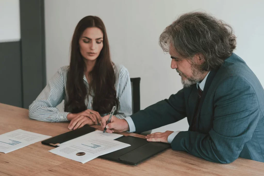 Business colleagues reviewing and signing documents.