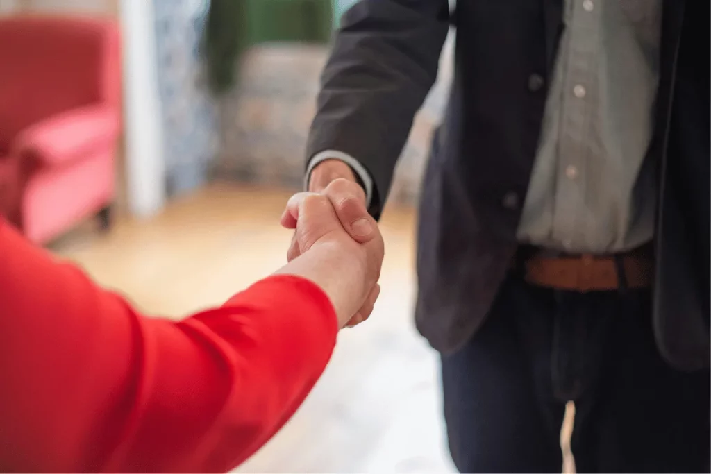 Handshake between two professionals in a business setting.