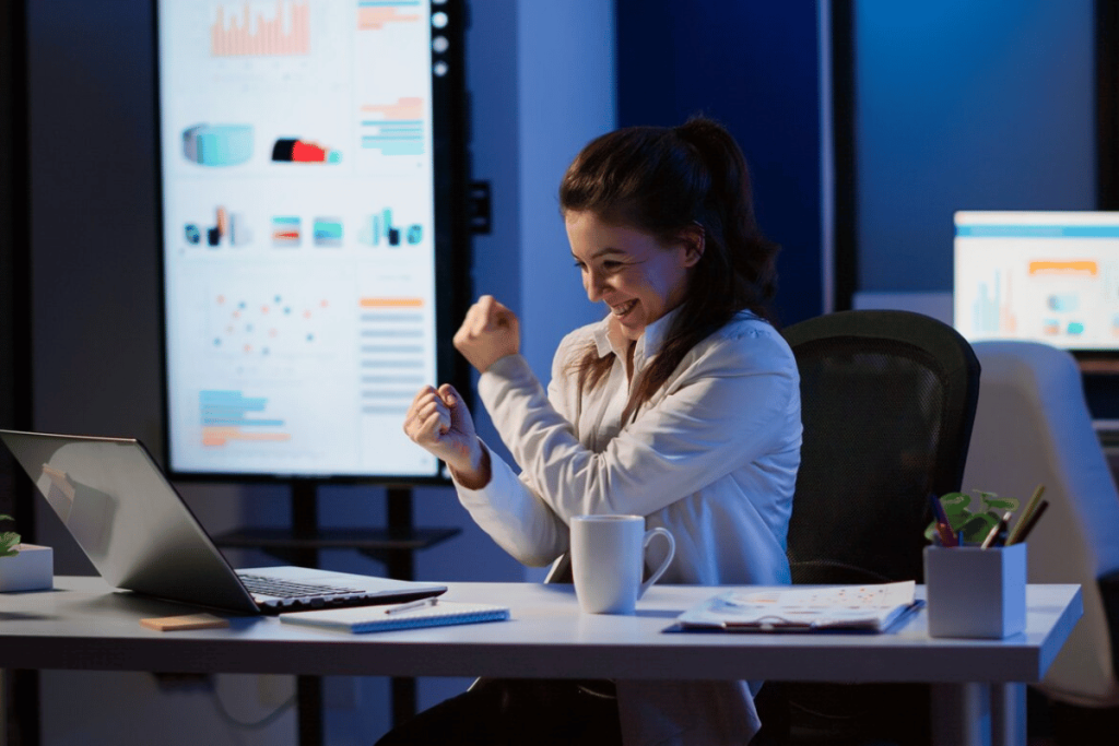 A person sitting at a desk in front of a laptop.