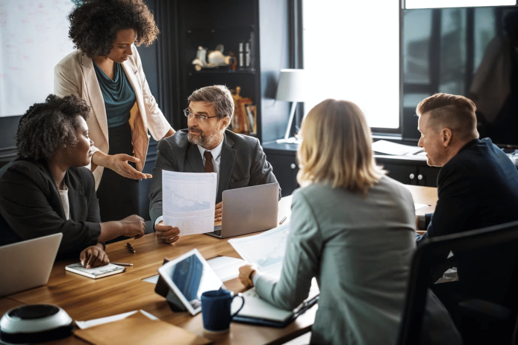 A group of people sitting around a conference table.