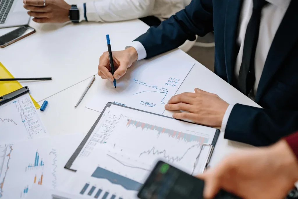 Professionals analyzing graphs and charts during a business meeting.