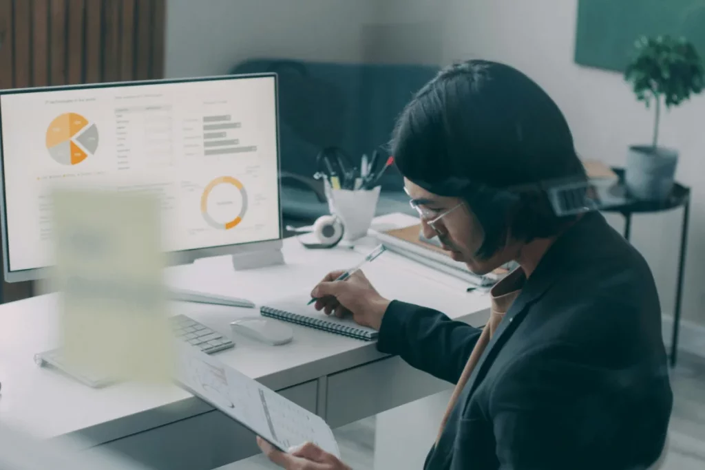 Business analyst reviewing financial reports and performance metrics.