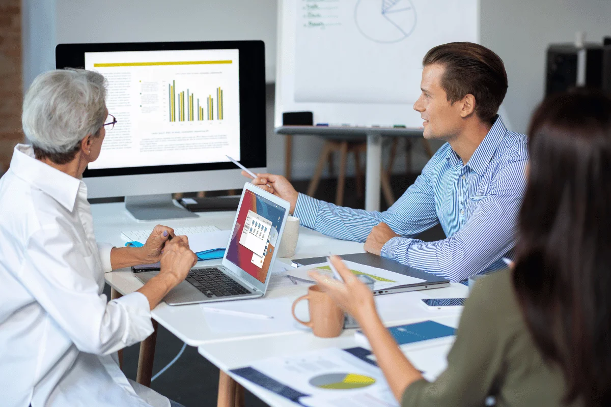 Group of professionals analyzing marketing metrics and graphs.