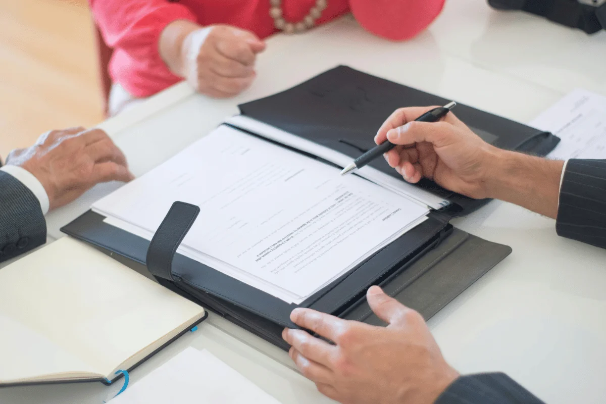 Legal document review and signature in a business setting.