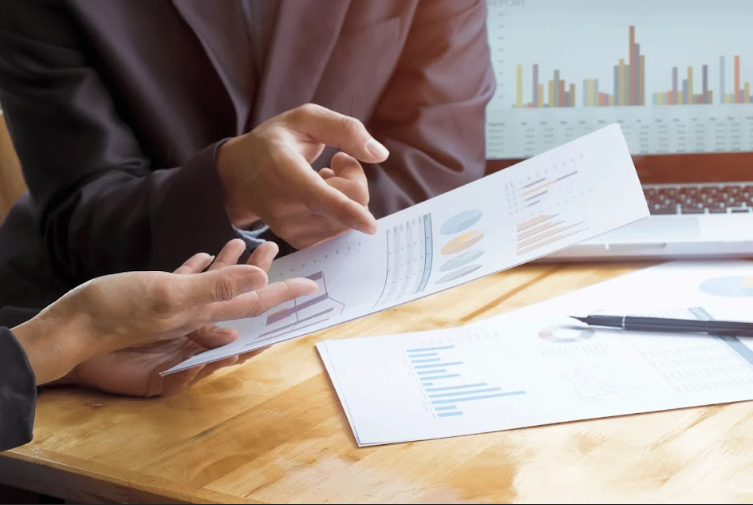 Business owner reviewing financial charts and reports for HVAC business valuation analysis.