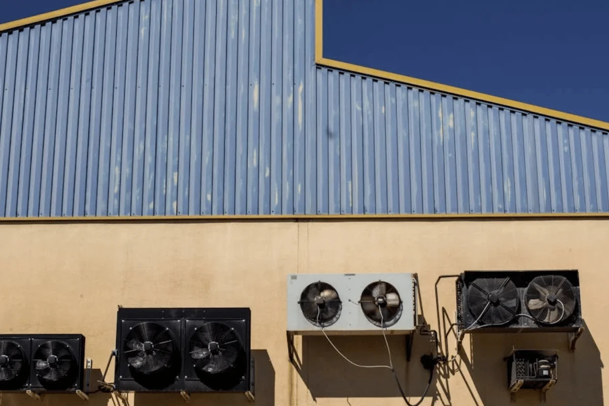 Commercial HVAC units mounted on building exterior wall showing heating and air conditioning equipment valuation
