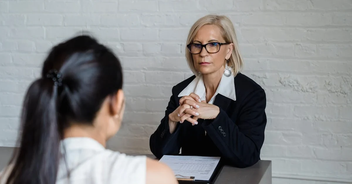 Business professional interviewing candidate at desk discussing SaaS ma firms selection process.
