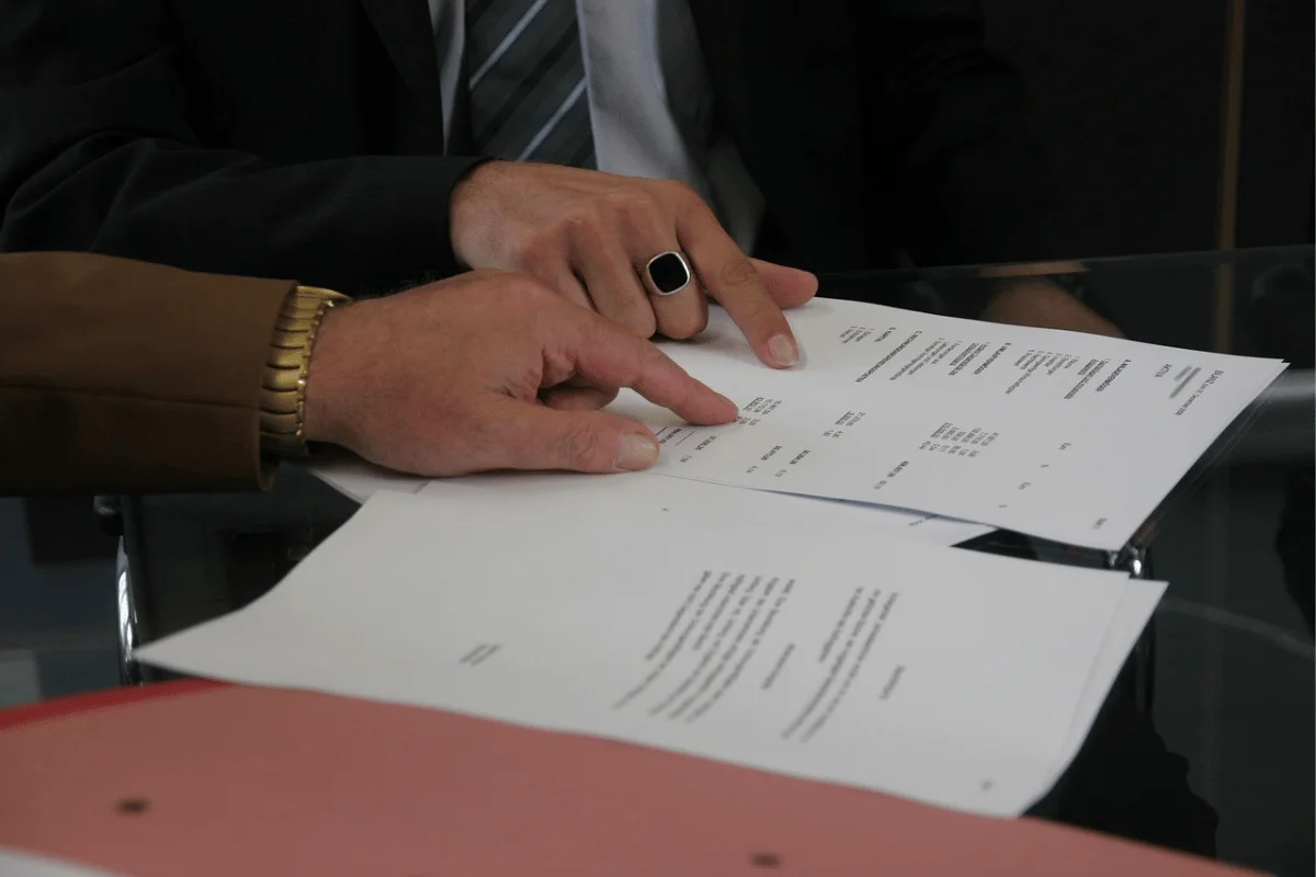 Detailed discussion over financial papers in a business setting.