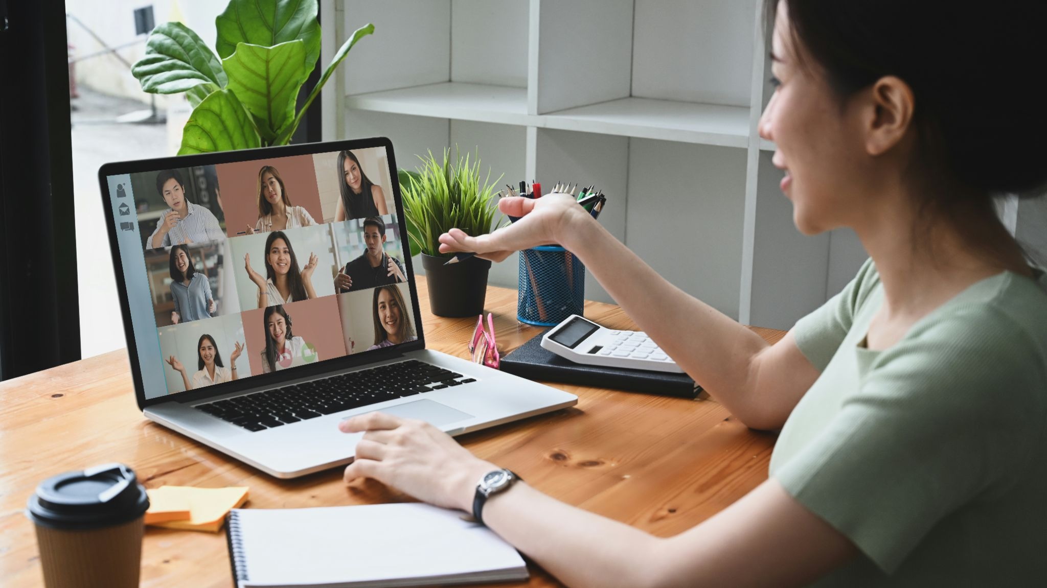A tutor running an online tutoring business leads a small-group online tutoring session from a laptop using a virtual classroom platform.
