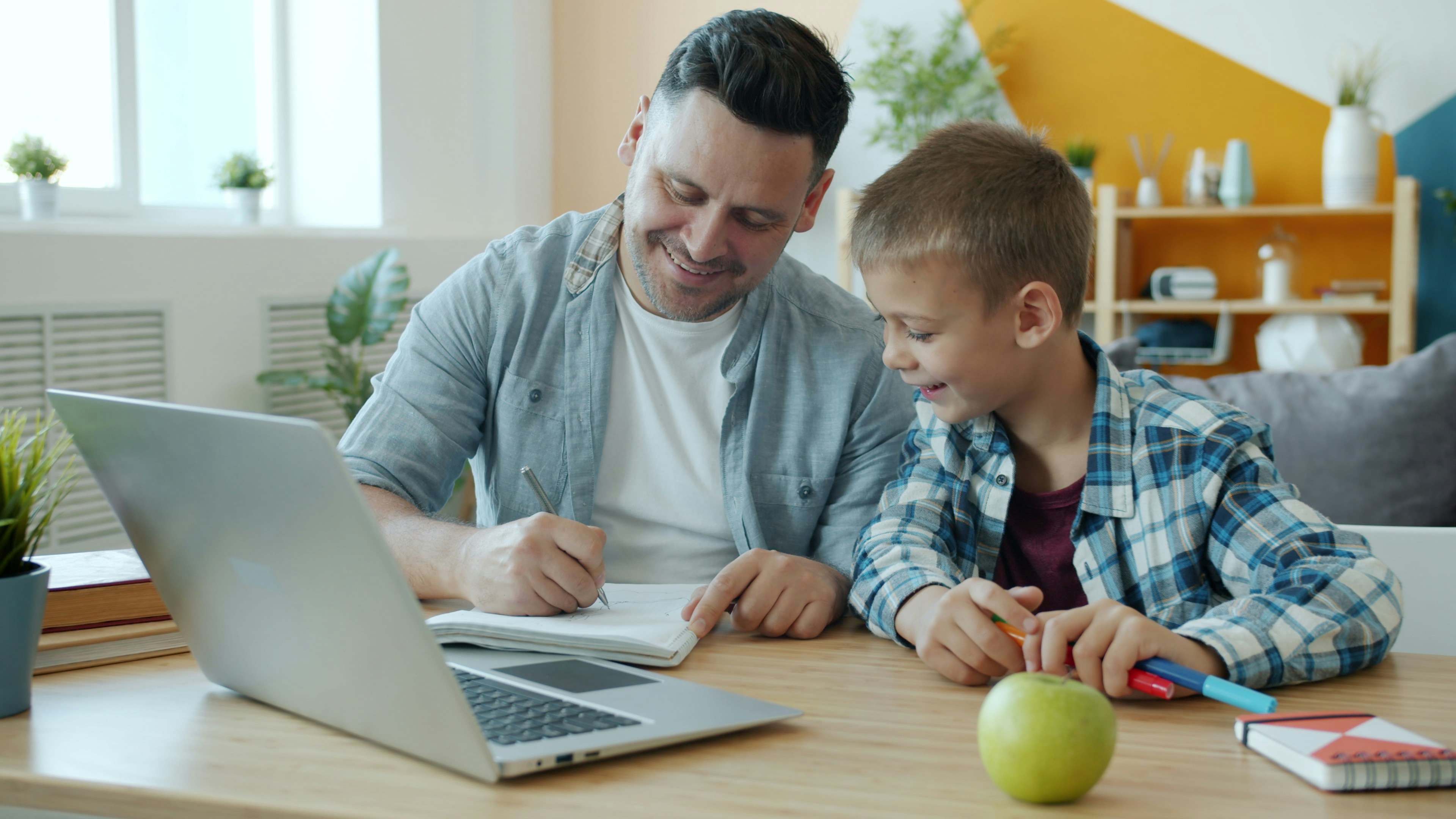 Father supervising a child during an online tutoring lesson on a laptop, highlighting COPPA compliance and children's online privacy in virtual learning.
